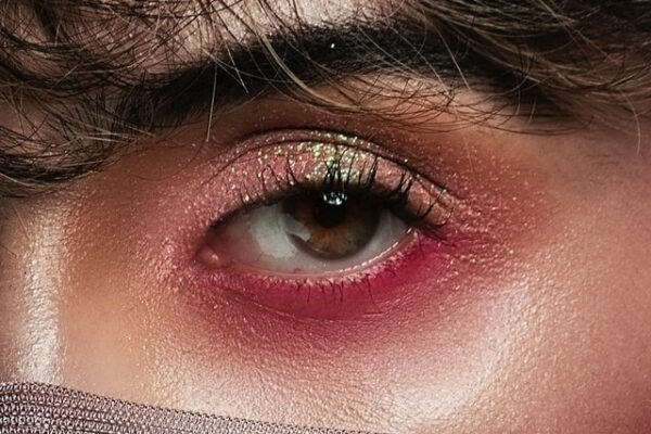 Das pink-glitzernde Augen-Make-up einer Frau in der Nahaufnahme